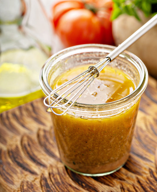 glass jar with a marinade & whisk