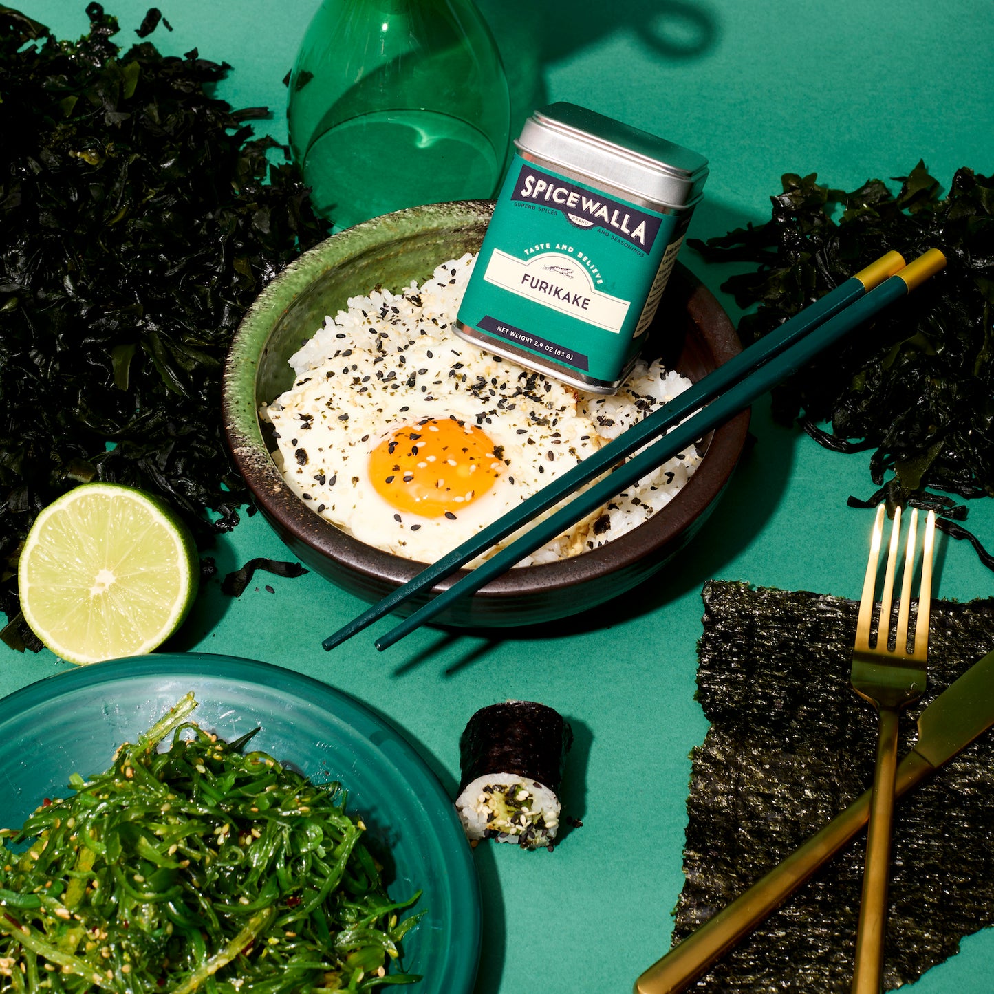 Spicewalla furikake sitting in a spiced bowl around asian foods with a green background
