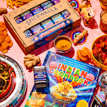 A styled flat-lay featuring a box of Spicewalla spices with Meherwan Irani's No. 1 Best Indian Cookbook in the World