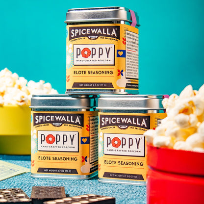 Spicewalla Poppy Elote Seasoning tins with popcorn on a blue background