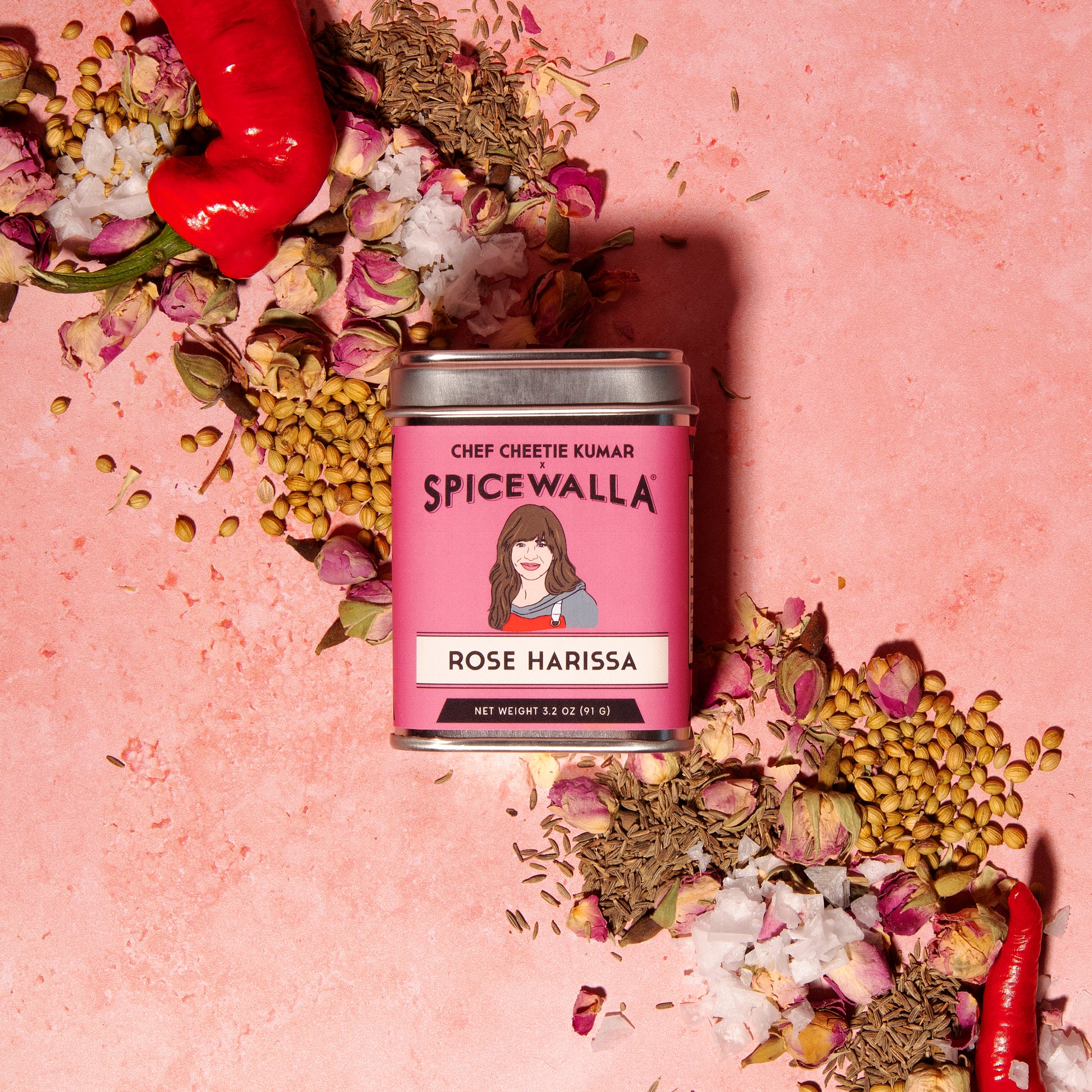 Spicewalla Rose Harissa with ingredients on a pink background