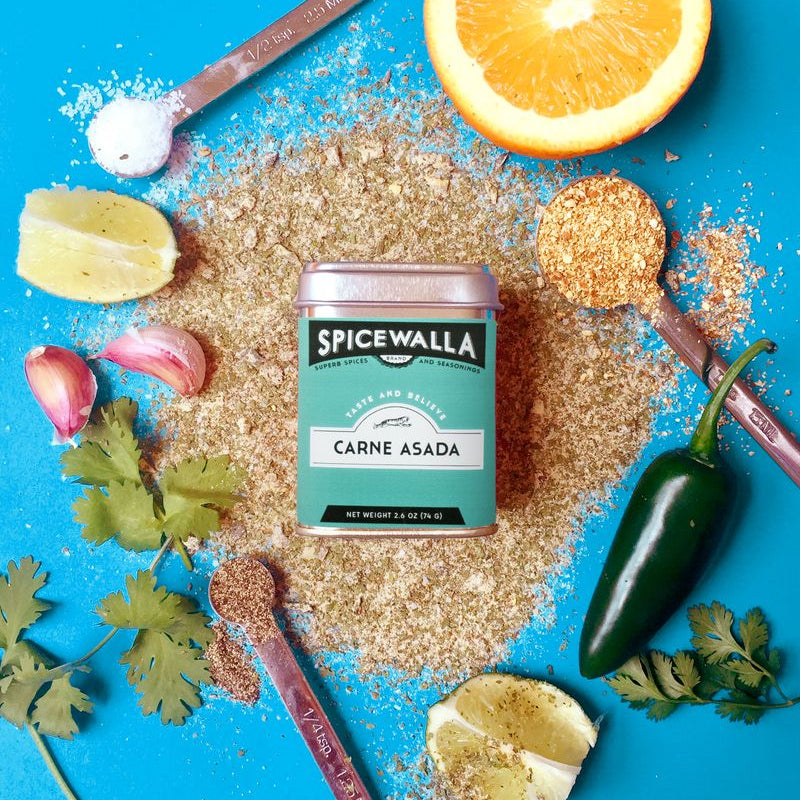 Spicewalla Carne Asada spice mix with ingredients on a blue background