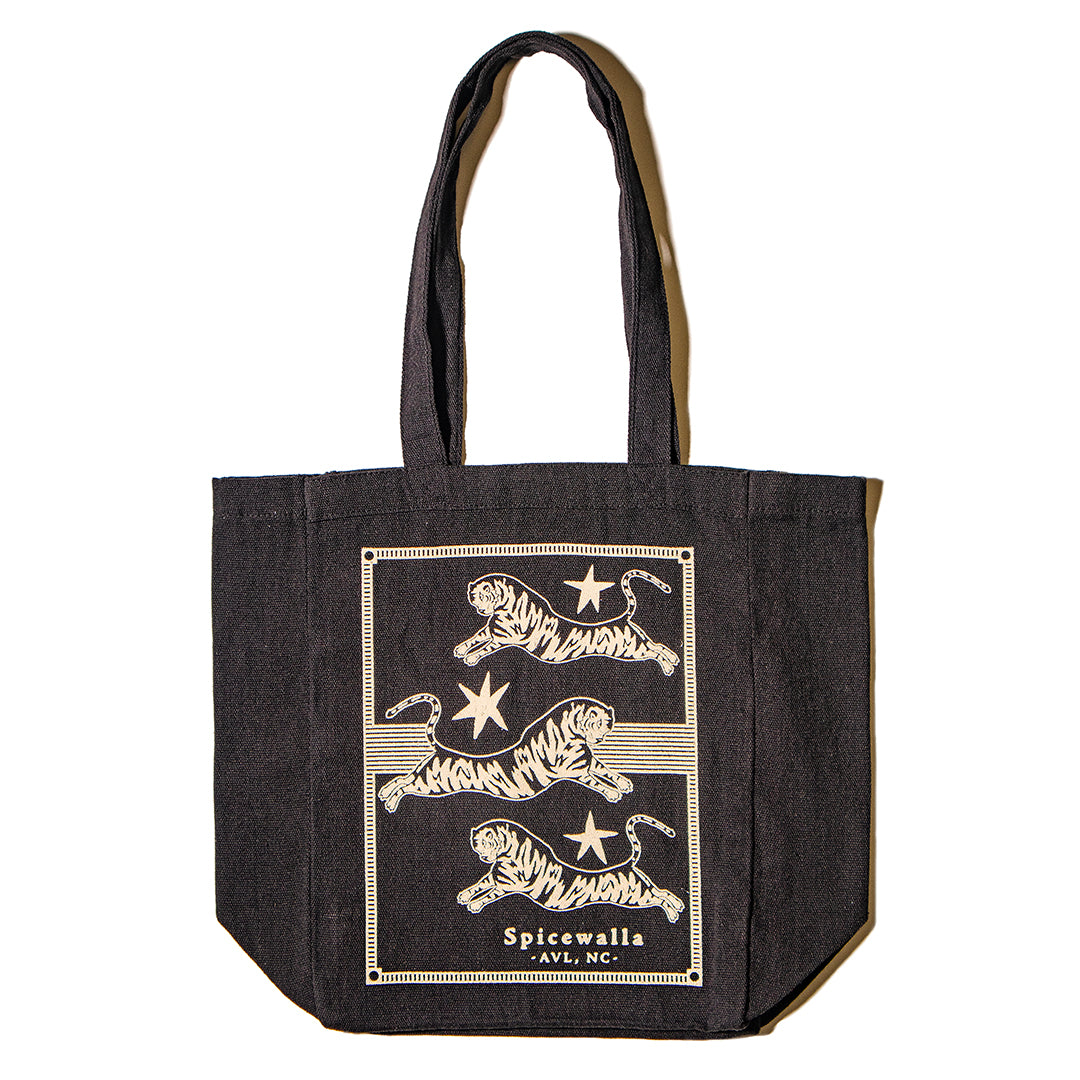 Black tote bag with white tiger design and 'Spiceworld' text on a white background
