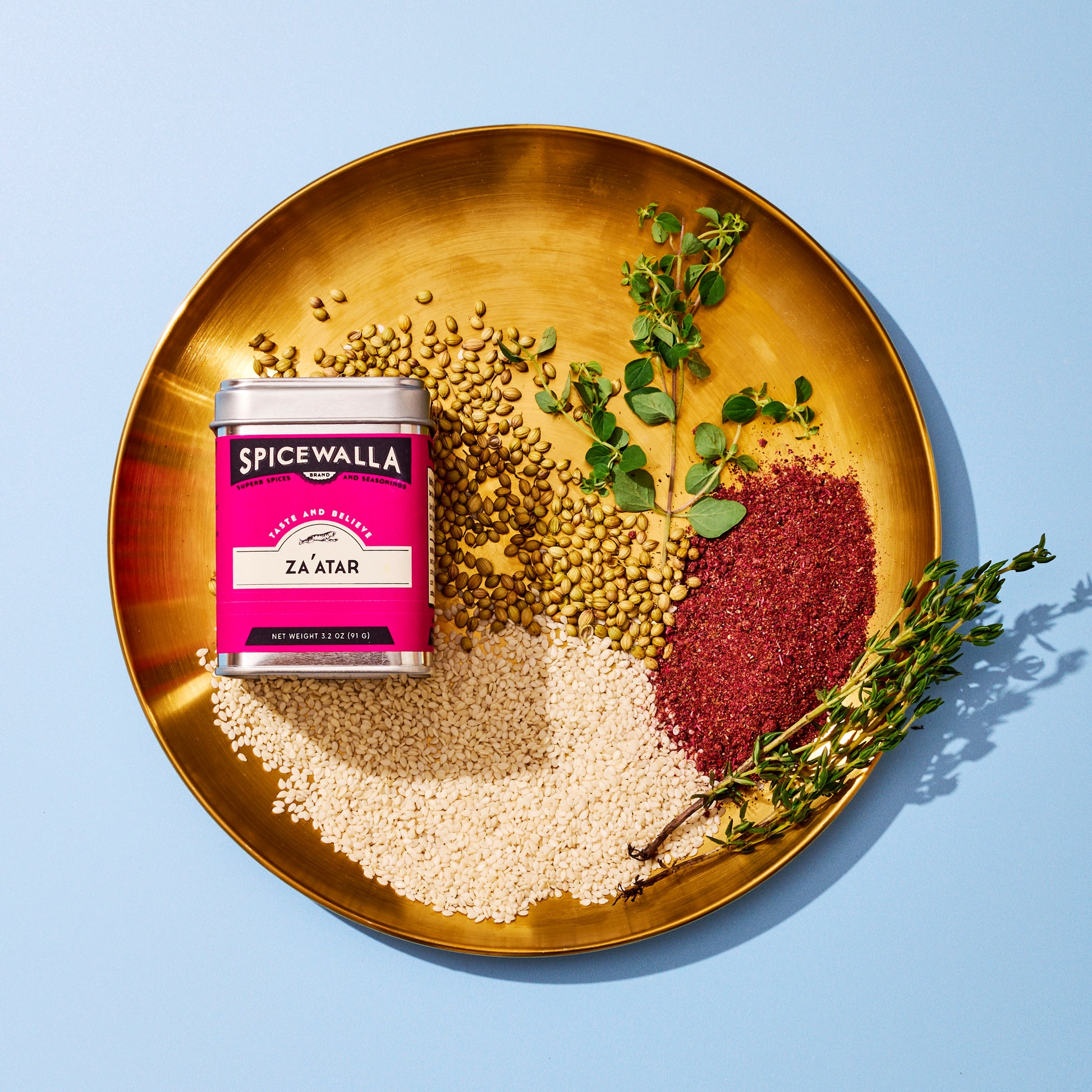 Spicewalla za'atar with herbs on gold plate with blue background
