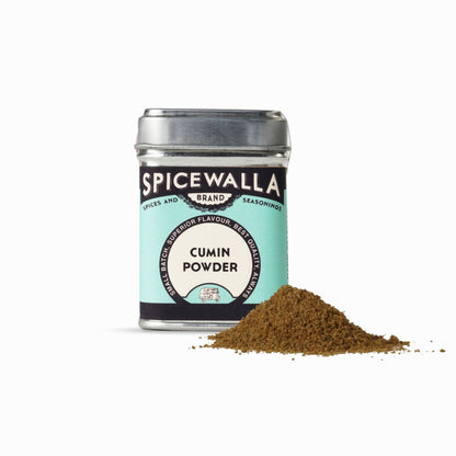 Spicewalla cumin powder jar with a small pile of cumin powder on a white background